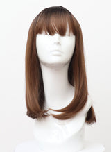 A synthetic wig on a mannequin head featuring a brunette/copper long bob with fringe.