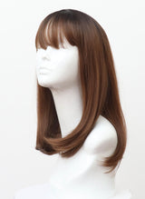 A synthetic wig on a mannequin head featuring a brunette/copper long bob with fringe.