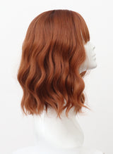 A mannequin head displaying a dark ginger wig with natural waves and a fringe.