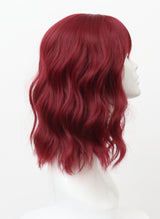 Plum colored wig with natural wave and fringe on a mannequin head.