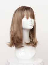 A synthetic dirty blonde shoulder-length wig with flicked tips and fringe displayed on a mannequin head.