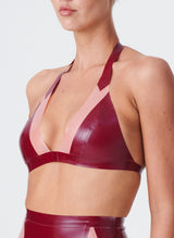 A plum latex bikini-style halter bra with Semi-Transparent pink inserts. The model wears the matching latex lingerie set.