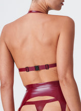 Back shot of a plum latex bikini-style halter bra with Semi-Transparent pink inserts. The model wears the matching latex lingerie set.