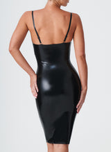 Back shot of a model wearing a shiny black latex knee-length dress, with adjustable skinny shoulder straps.