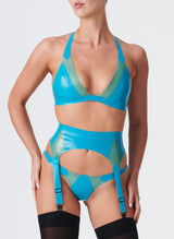 A model wearing an aqua coloured latex lingerie set with Semi-Transparent jade inserts. The latex lingerie set includes a bikini-style halter bra, four strap suspender belt and thong. Model wears black nylon stockings.