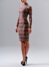 A model on a grey background wears a semi-sheer leopard print mesh dress with high collar and long sleeves. The dress finishes on the knee.