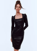 A model wearing a soft black leatherette pencil dress with square neckline and gathered sleeve heads.