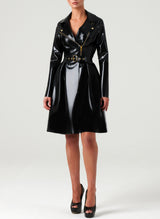 A person wearing a black latex biker Mac with gold metal zip and hardware, long pleated peplum, and a matching belt that is not attached.