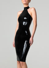 A person wearing a black latex pencil dress with a wide halter neck collar and a low back, fastened with press studs.