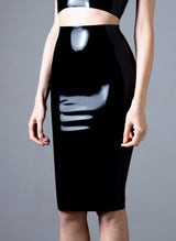 A model on a grey background wears a black latex pencil skirt.