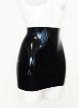A black latex mini skirt on a white mannequin.