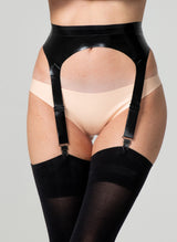 A person wearing a black latex suspender belt with four adjustable straps, paired with pale peach latex hipster briefs and black stockings.