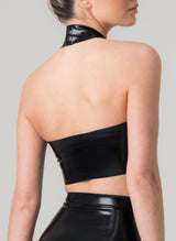 Back view of a person wearing a black latex halter neck cropped top with a choker collar.