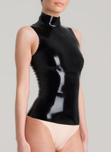 A person wearing a sleeveless black latex top with a high collar and a full back zip.