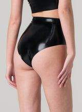 Back view of a person wearing black latex high-waisted knickers.