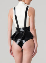 Back view of a sleeveless latex blouse with a flared peplum and mock shirt front, featuring a bow tie and braces. The blouse is primarily black with white upper section. Worn with matching black latex knickers.