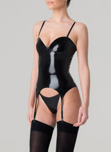 Side shots of a person wearing a black latex basque with adjustable shoulder straps and suspender straps, featuring a zip fastening at the back, presented against a grey background, and worn with a matching G-string and black stockings.