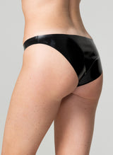 Back view of a model wearing black latex hipster briefs.