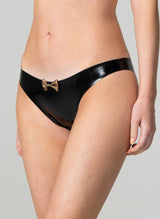 Black latex rubber briefs with a gold mini bow at the front, worn by a model.