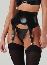 A black shiny latex suspender belt with gold metal sliders and suspender clips. Worn with matching G-String and black opaque stockings.