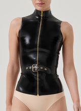 A person wearing a black latex top with a front gold zipper and a detachable belt with an adjustable buckle.