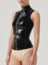 A person wearing a black latex top with a front gold zipper and a detachable belt with an adjustable buckle.