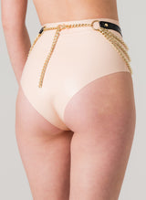 Back view of black leather belt with gold chains and rings, worn over peach latex high-waisted knickers.