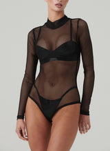 A black fishnet bodysuit with long sleeves and a high neck. Worn over black latex bra and G-string.