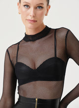 A model wears a black fishnet bodysuit with long sleeves and a high neck. Worn over black latex bra.